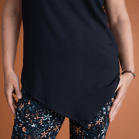 Haut noir à manches courtes avec pointe asymétrique fait au Québec, Canada.